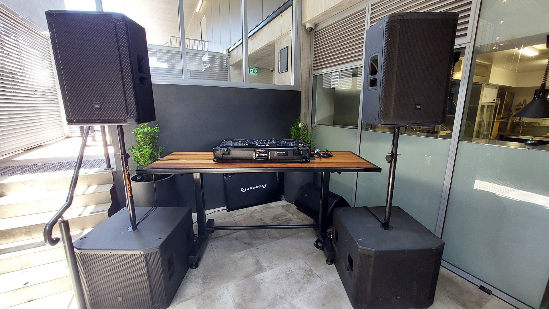 A dj booth with a table and speakers in a room.