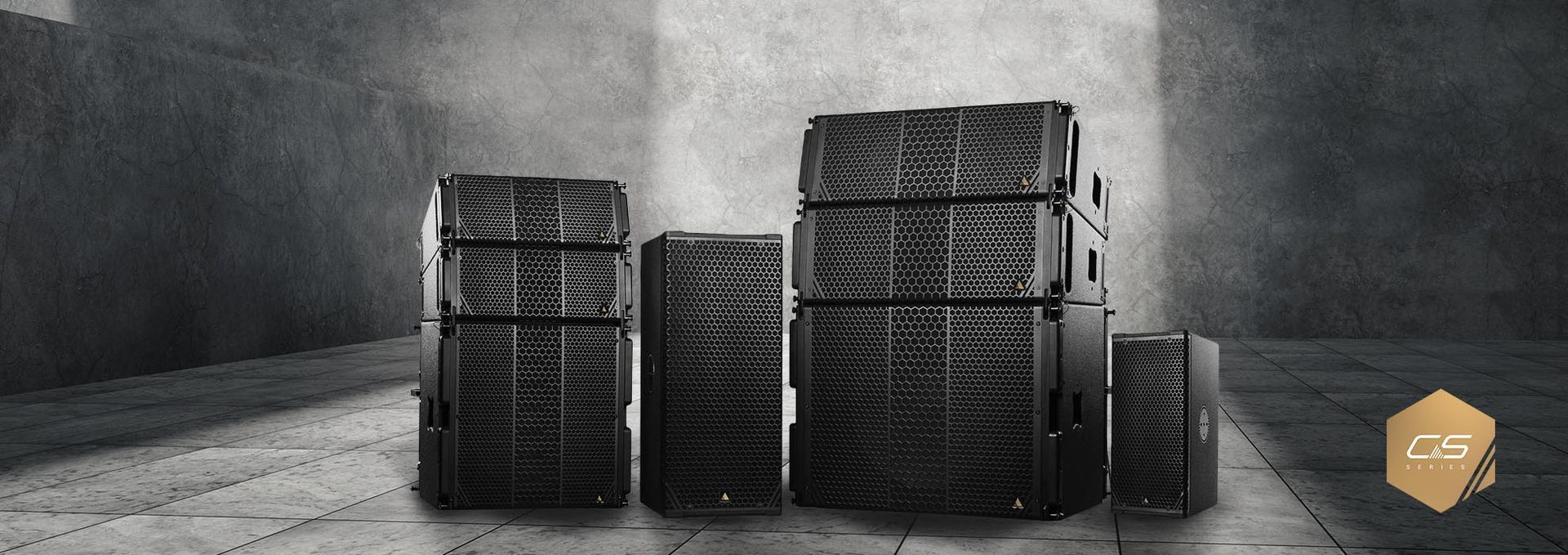 A group of speakers are stacked on top of each other in a dark room.