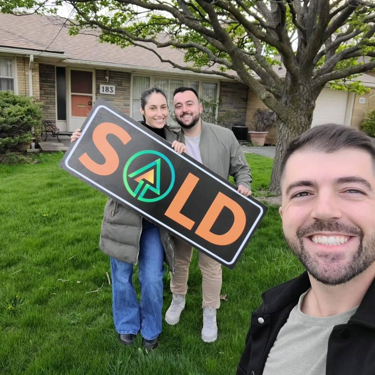 Three people holding a 