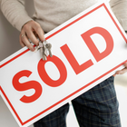 real estate sold sign with keys