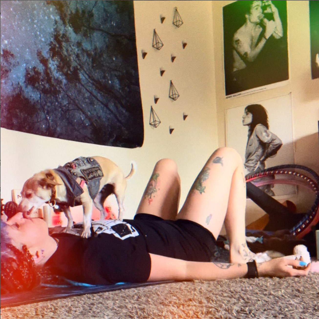 April on the yoga mat getting licked in the face by her chihuahua