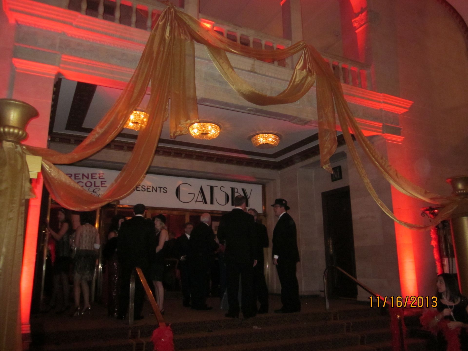 A group of people standing in front of a building that says caddey