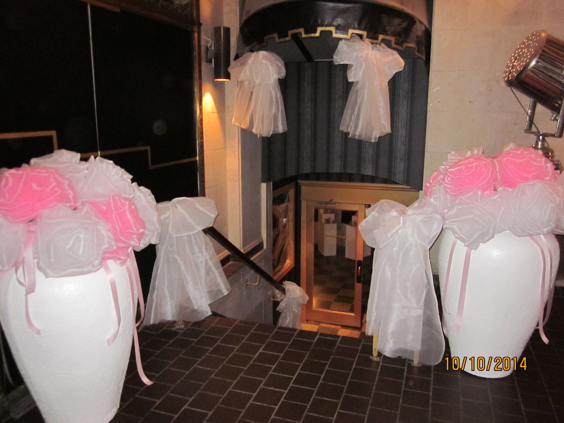 Two white vases filled with pink and white flowers