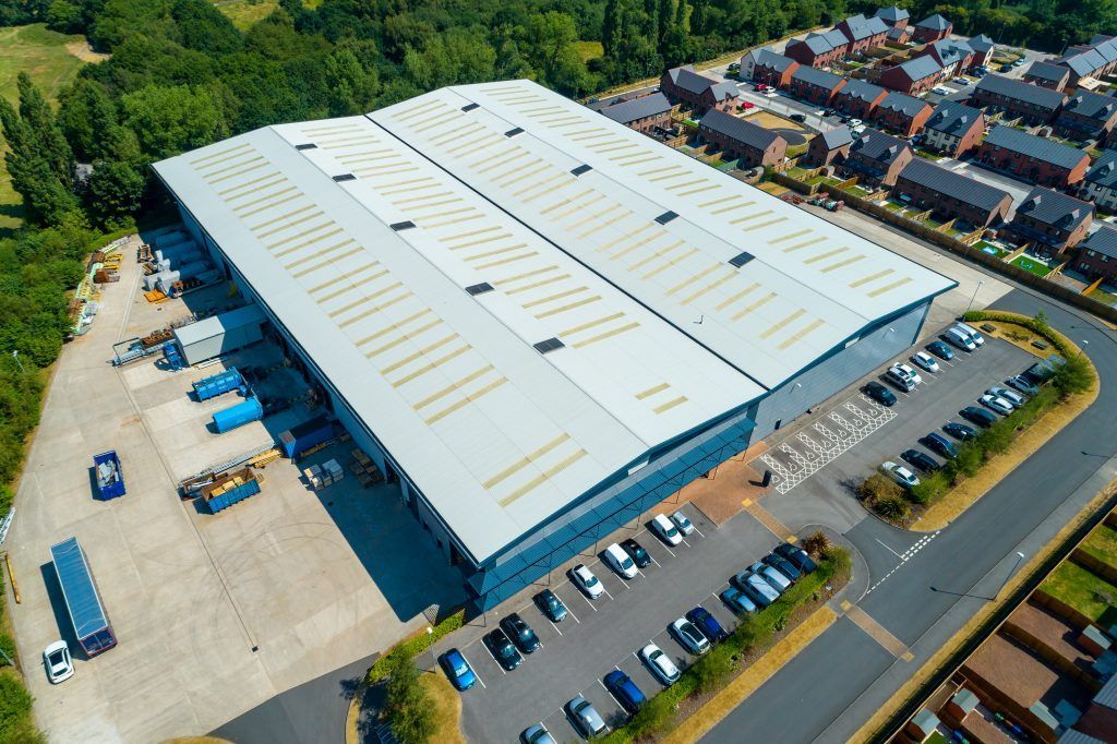 Blue house with gray roof, under blue sky.