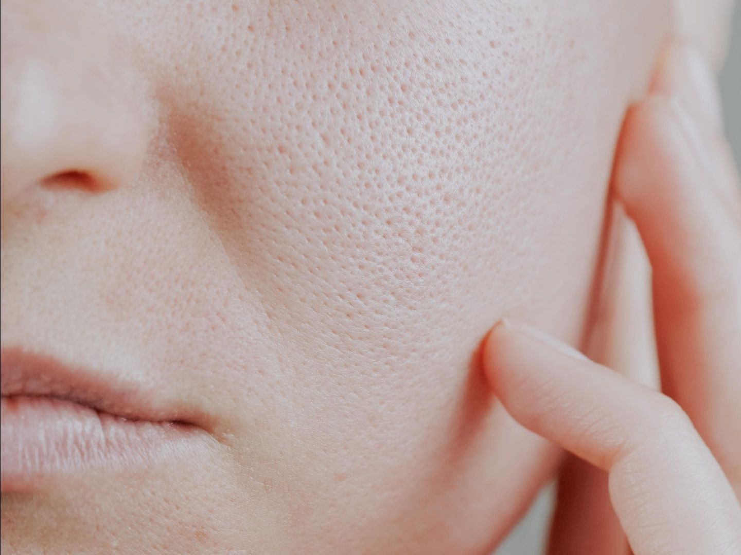 A close up of a woman 's face with a lot of pores.