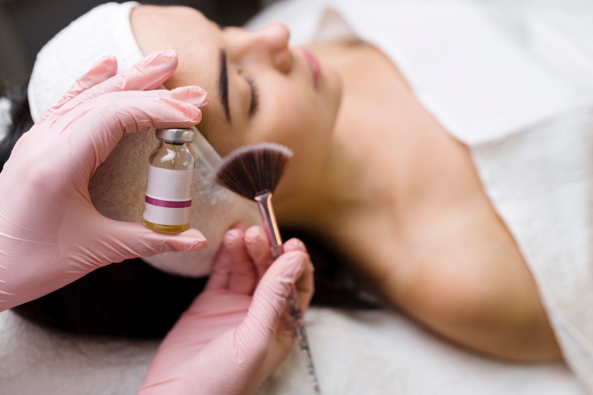 A woman is getting a facial treatment at a spa.