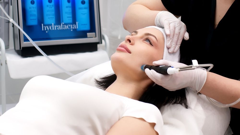 A woman is getting a facial treatment at a beauty salon.