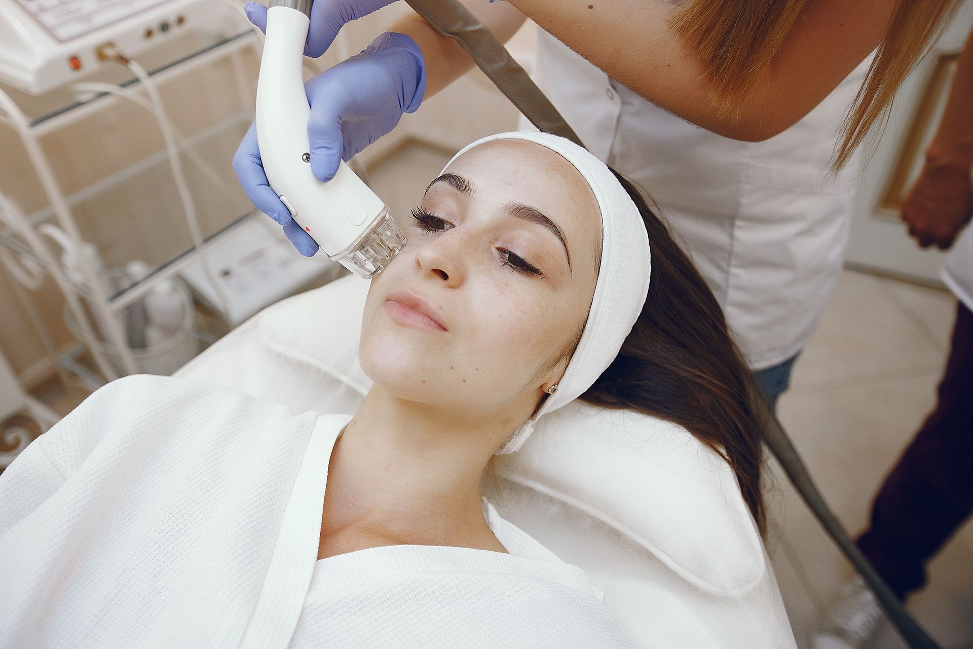 A woman is getting a facial treatment in a beauty salon.