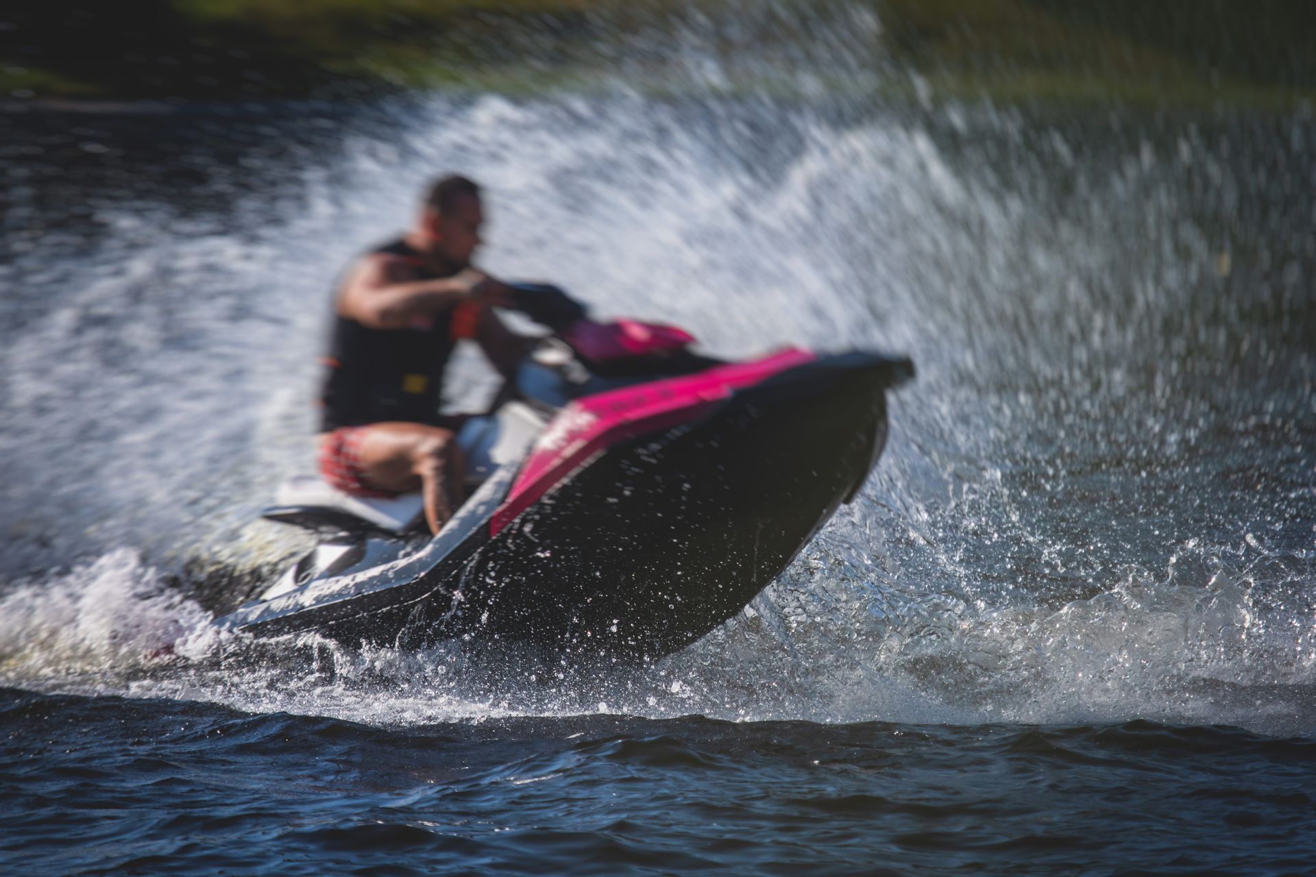 A man is riding a jet ski on a lake.
