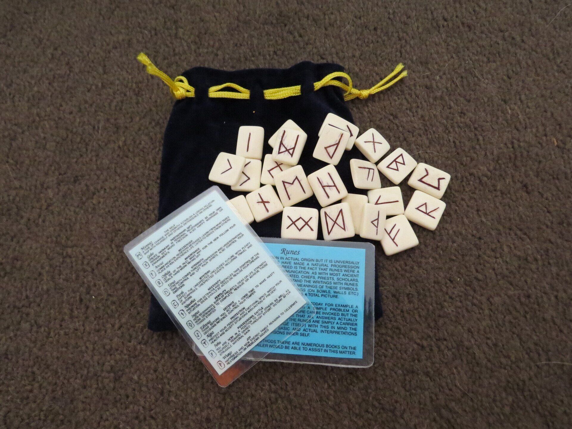 A bunch of runes are sitting in a black bag