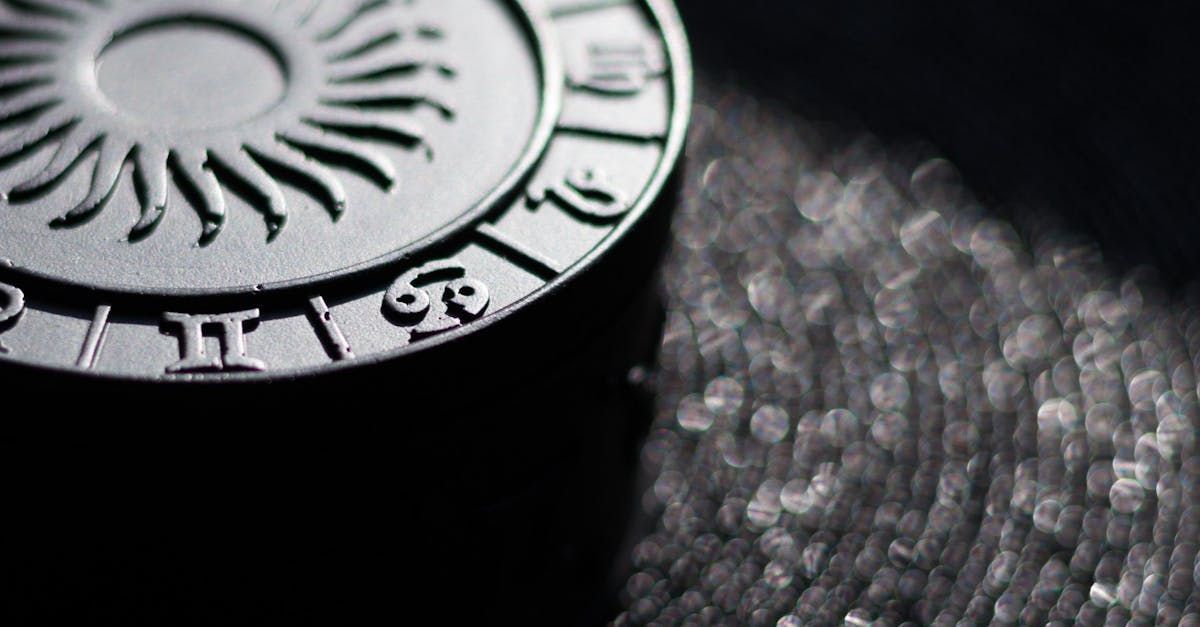A close up of a zodiac sign on a black surface.