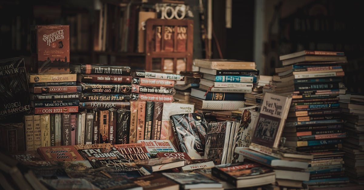 A bunch of books are stacked on top of each other on a table.