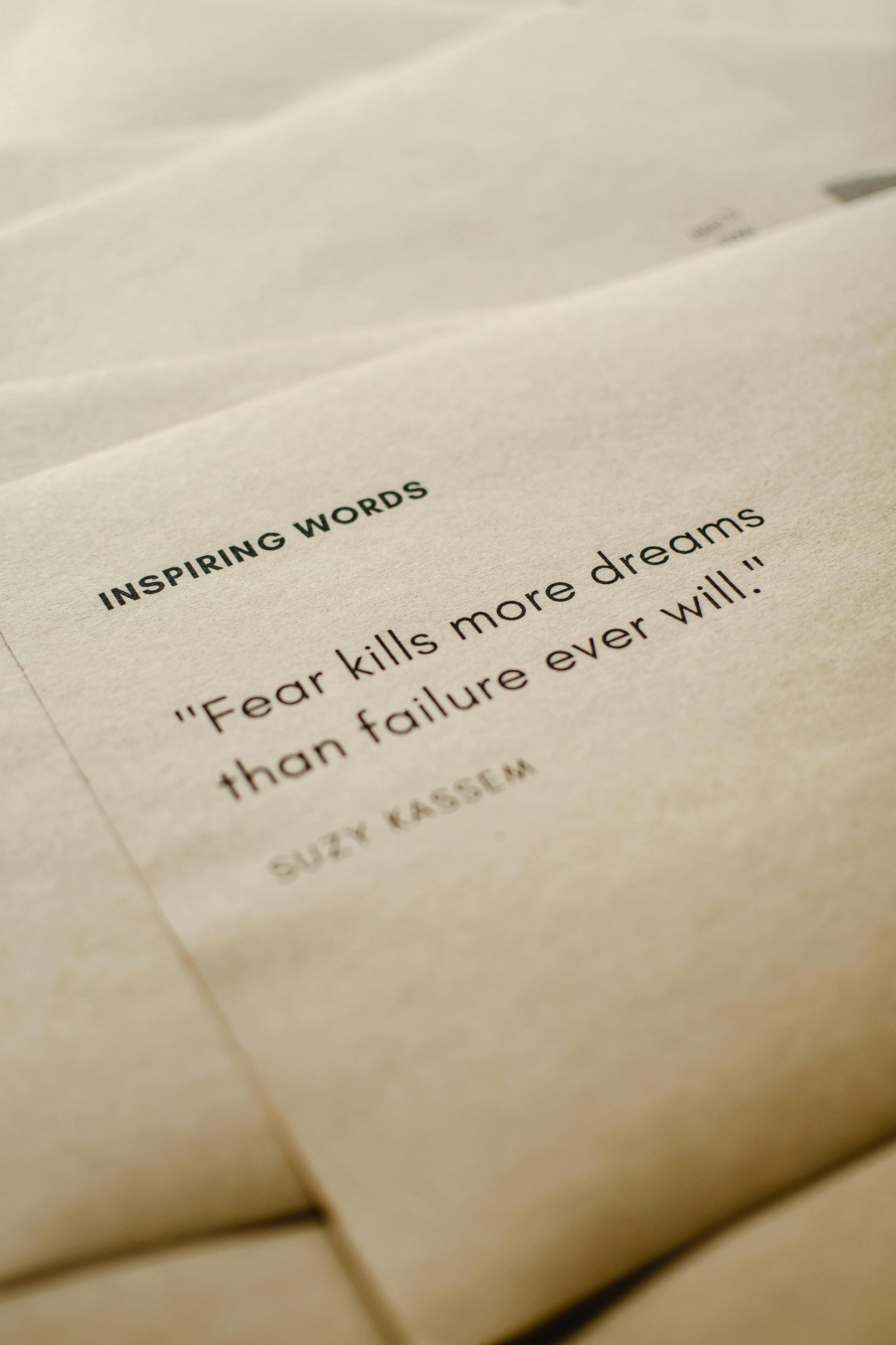 Close-up of tan envelopes with an inspirational quote:
