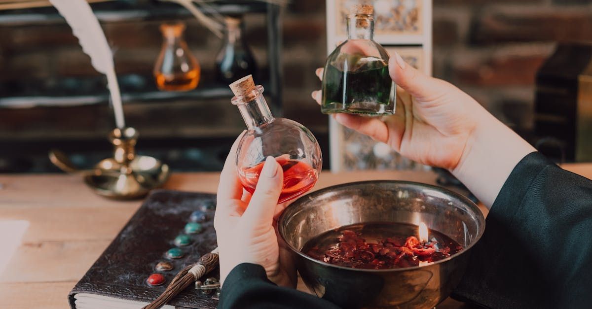 A person is holding a bottle of liquid next to a bowl of liquid.