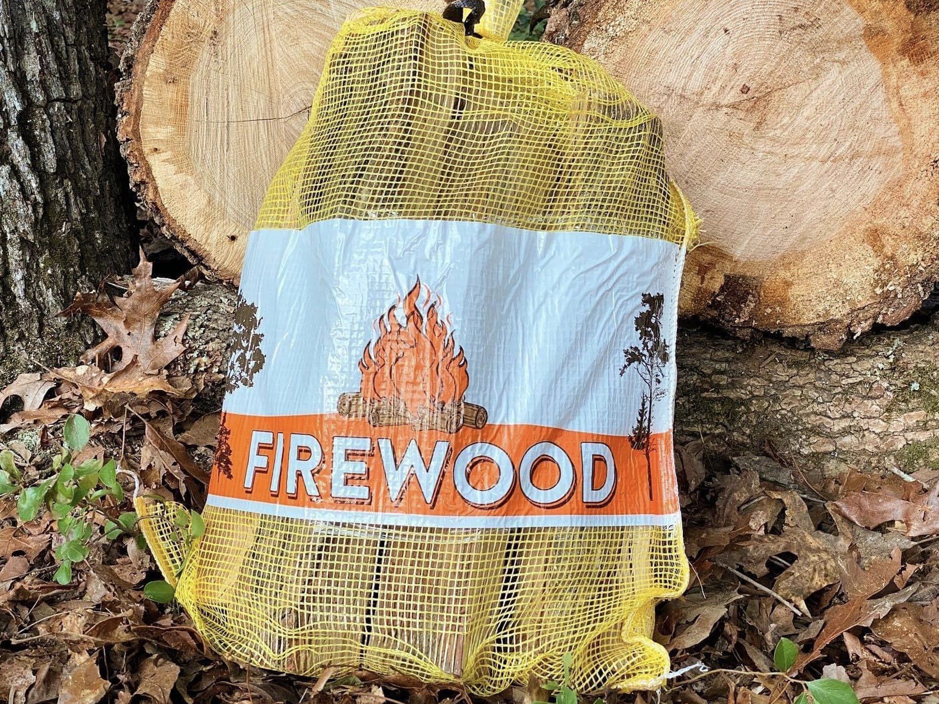 Bag of firewood against a backdrop of logs; the bag has