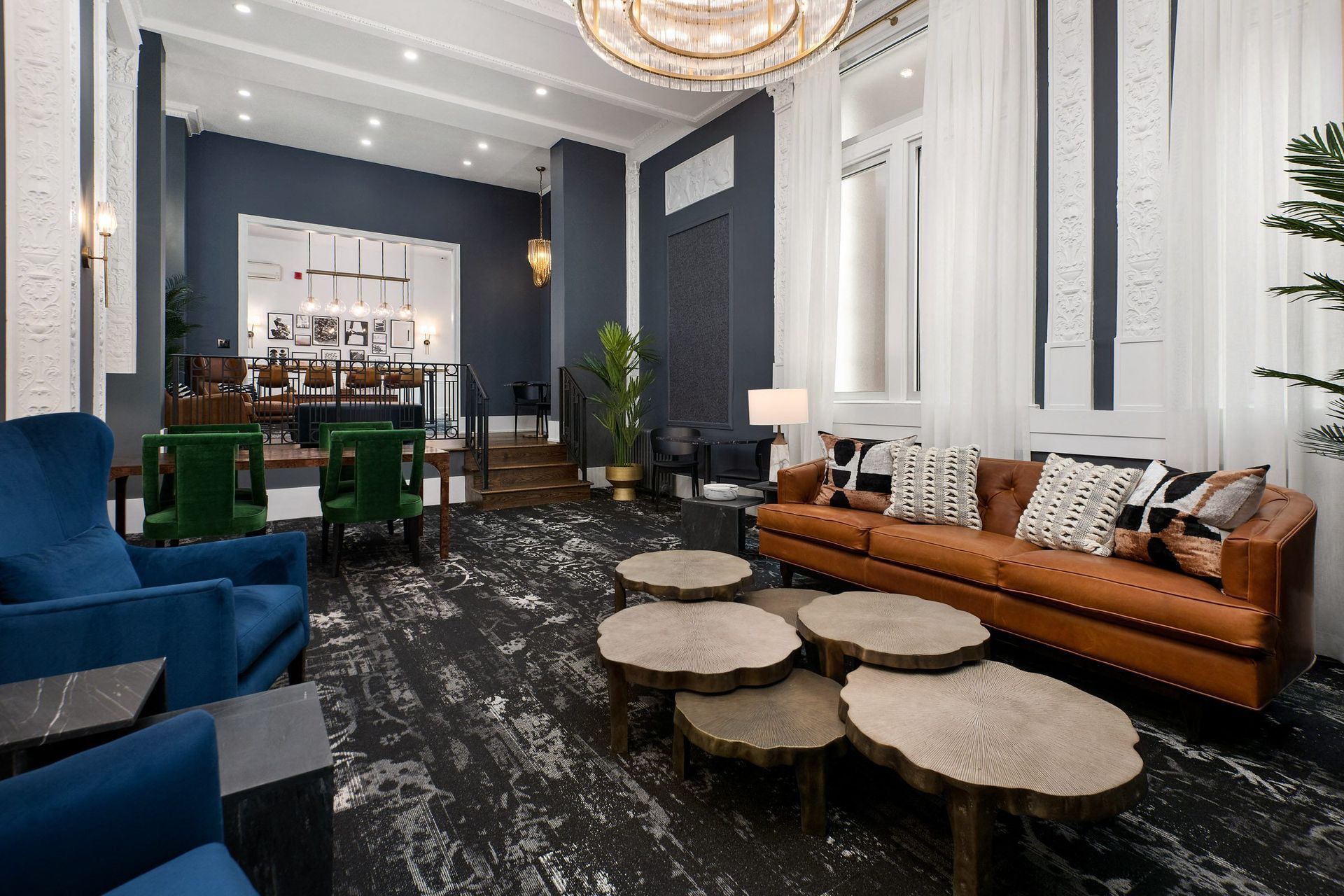 a living room filled with furniture and a large chandelier