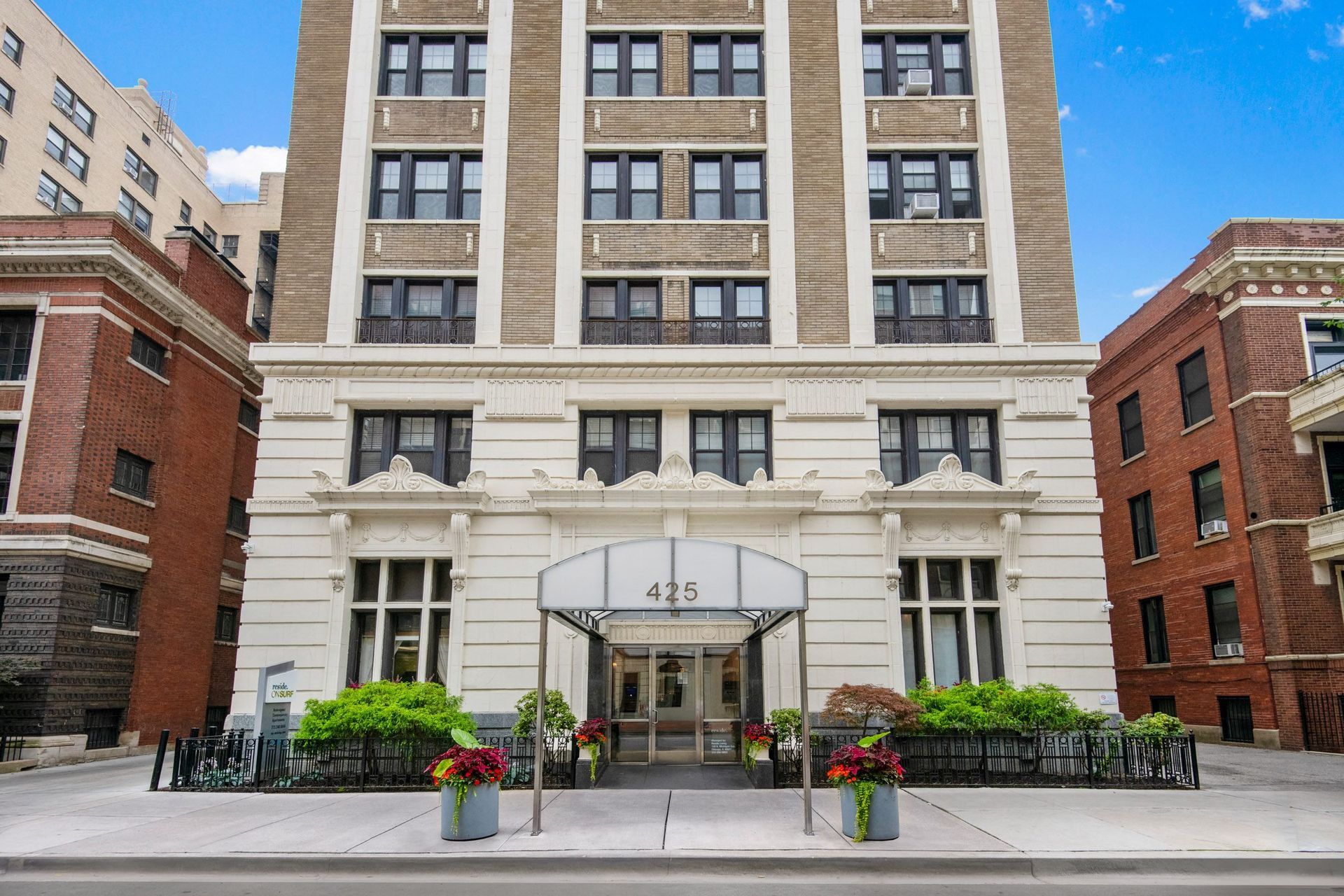 a large white building with a black awning in front of it