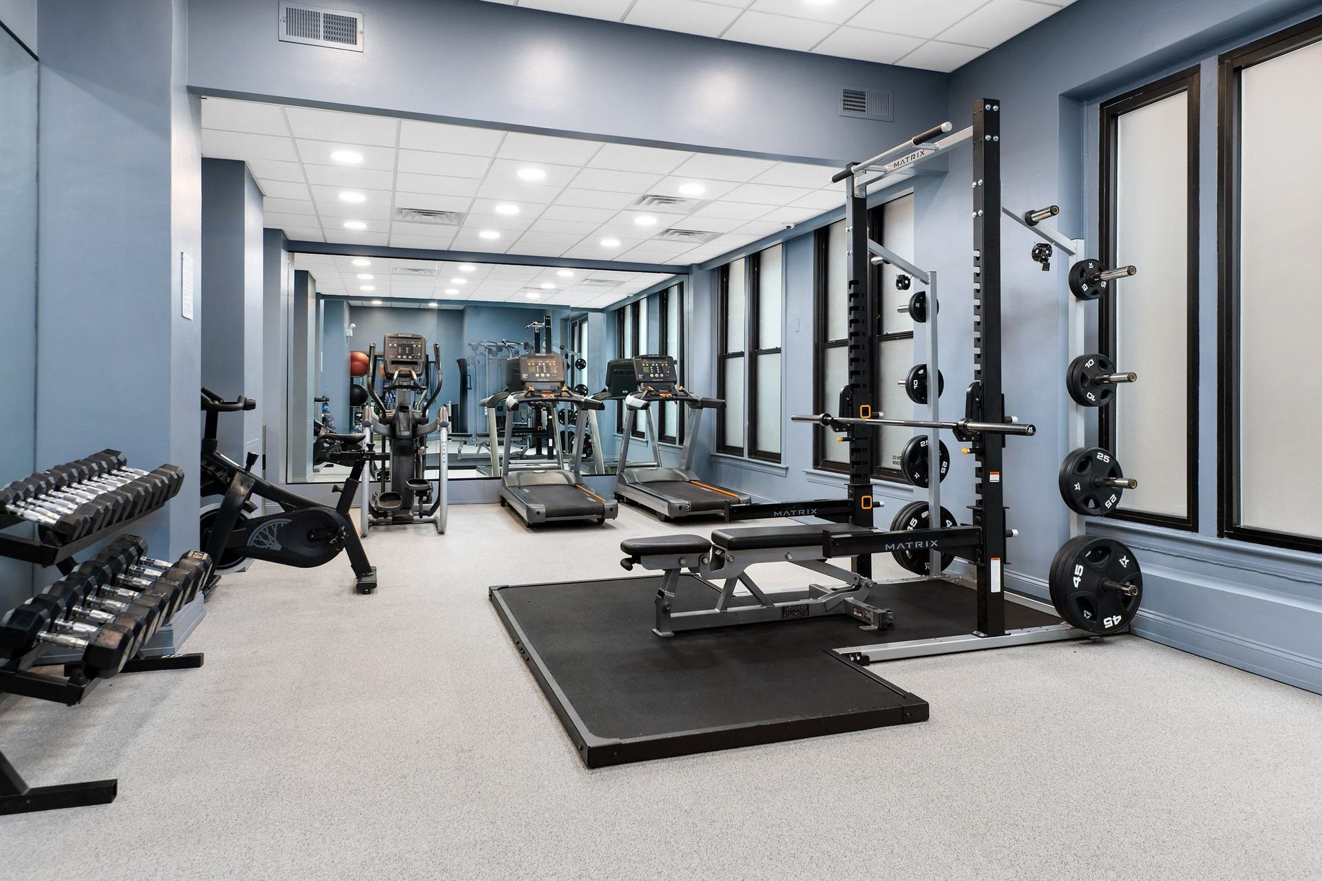 a large fitness room with weights and other exercise equipment