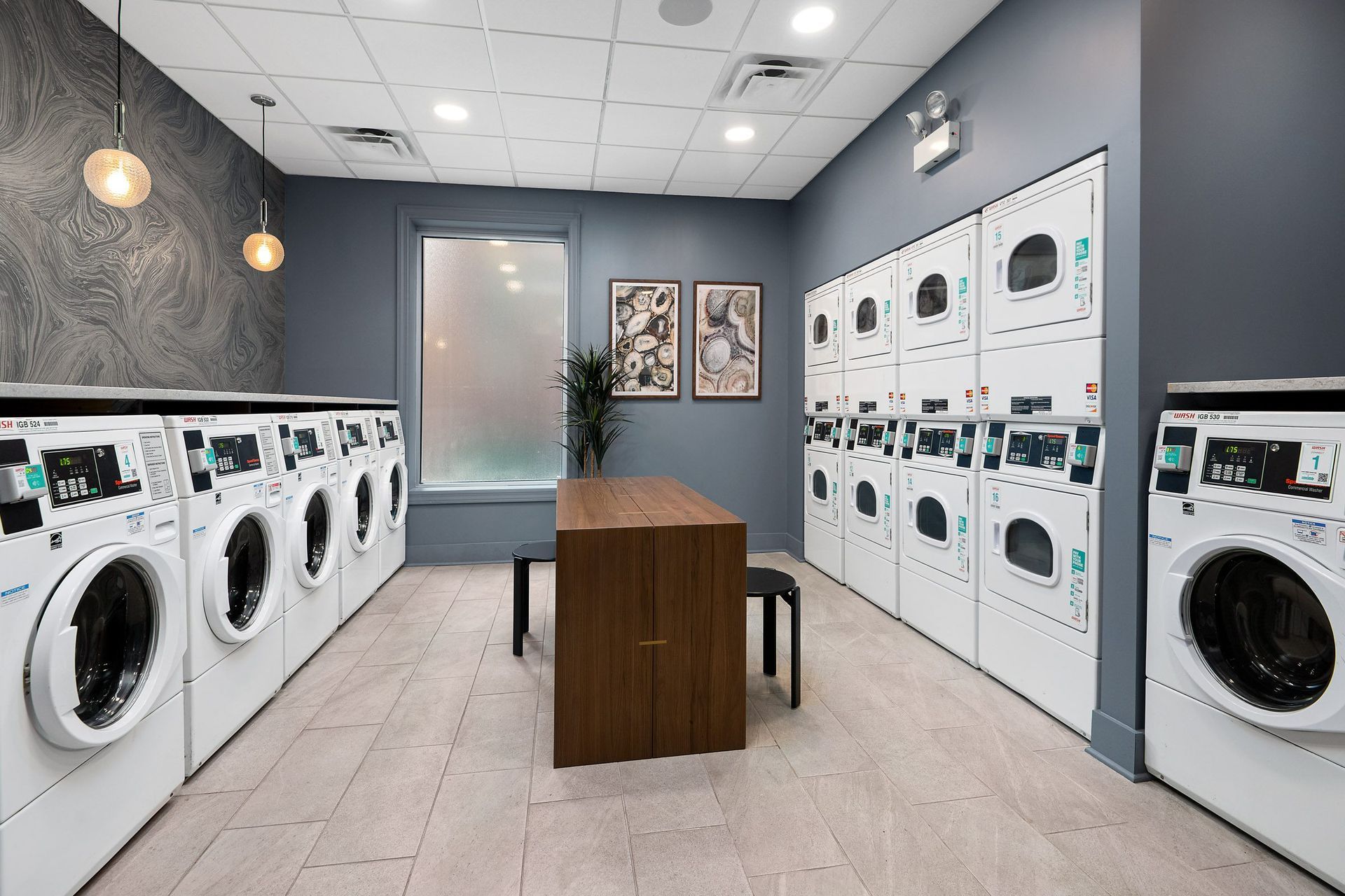 a laundromat with a table and washers and dryers