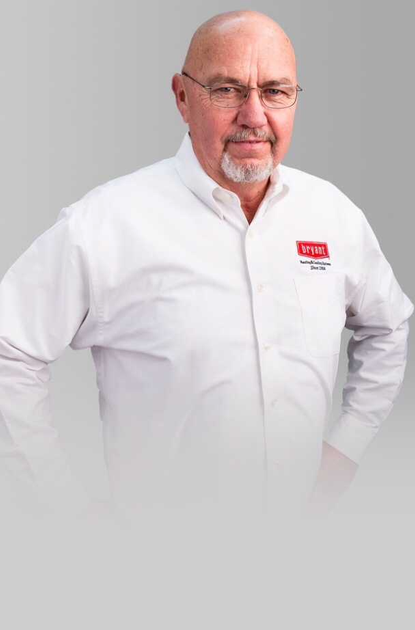 A man with glasses and a beard is wearing a white shirt with a red Bryant logo on it.