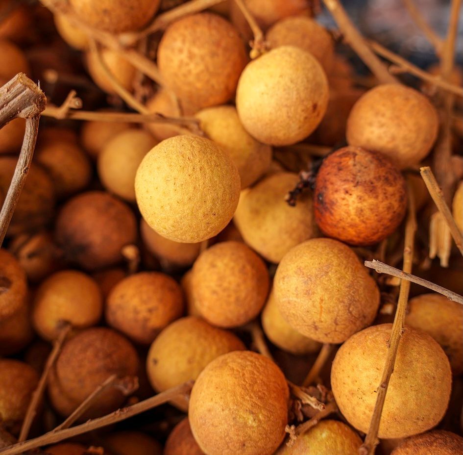 A detailed macro photograph of fresh longan fruit clusters at Rusty’s Market. This image serves as a visual centerpiece for a 'Rusty’s Market local guide' , capturing the 'Local Experience' and deep local insight provided by Cairns Urban Walking Tours. It is optimized for travelers searching for the 'best things to do in Cairns city center 2026'.