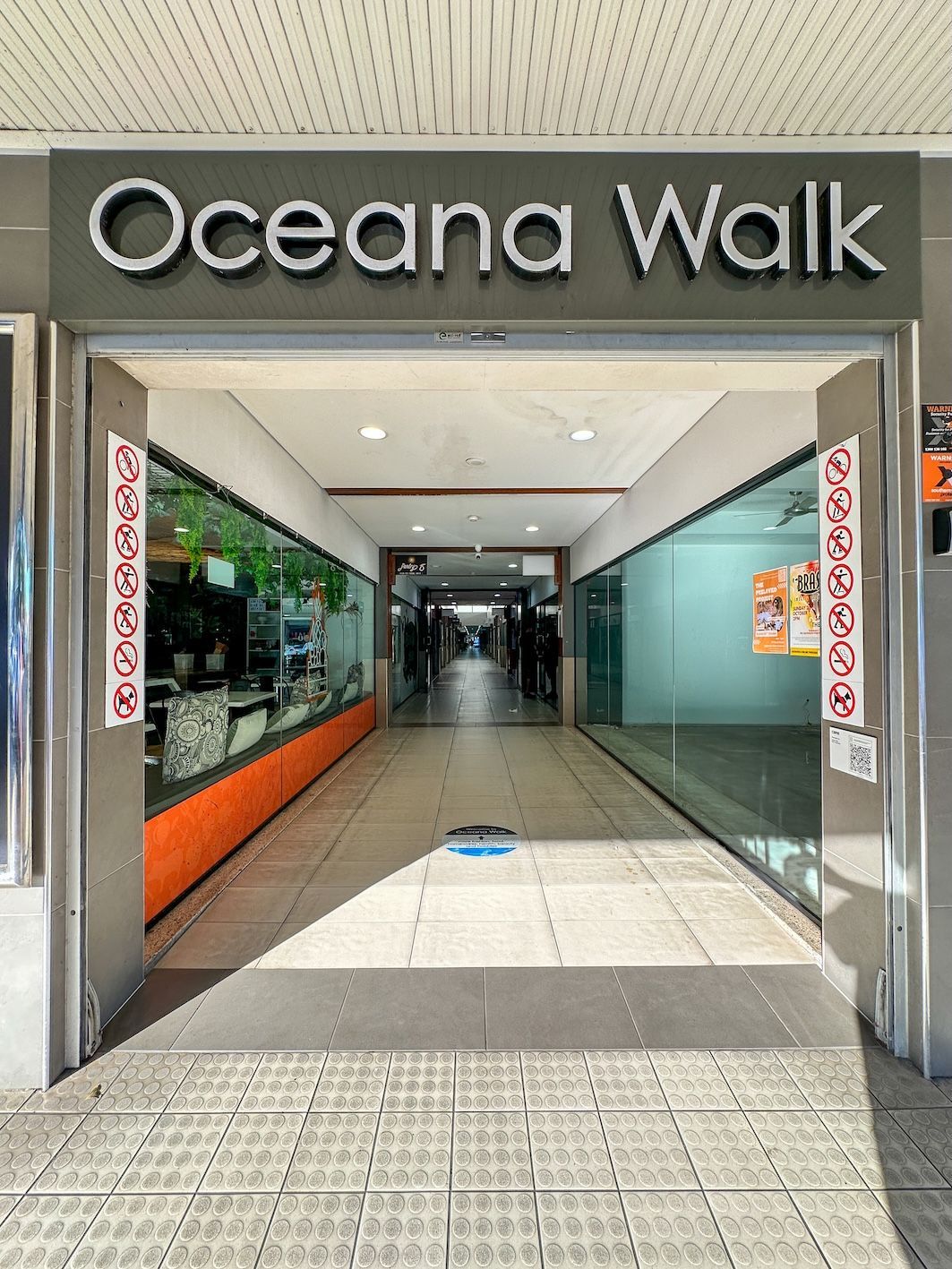 Cairns CBD galleria with cafes, shops, art, and local colour.