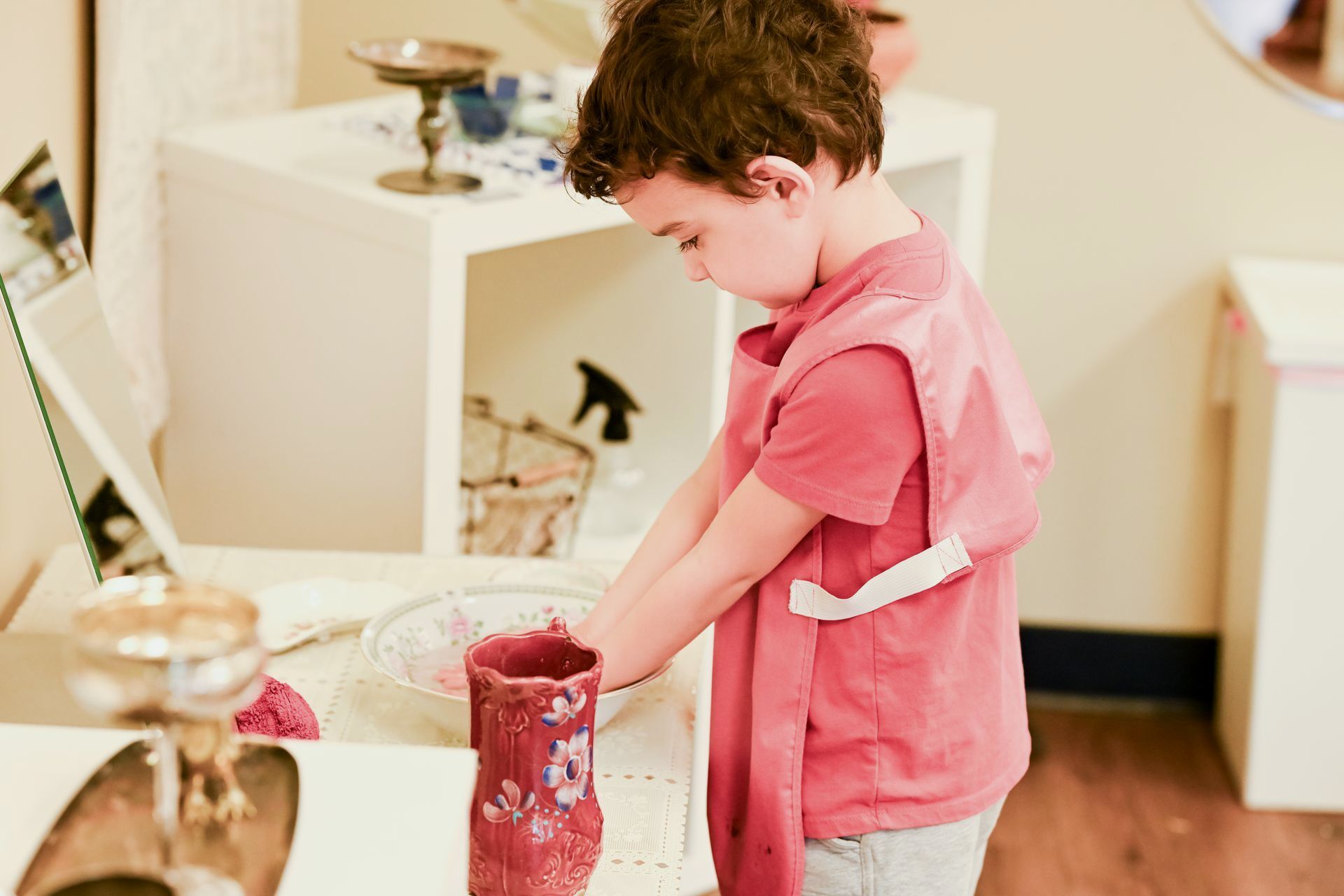 A Montessori child working on practical life skills