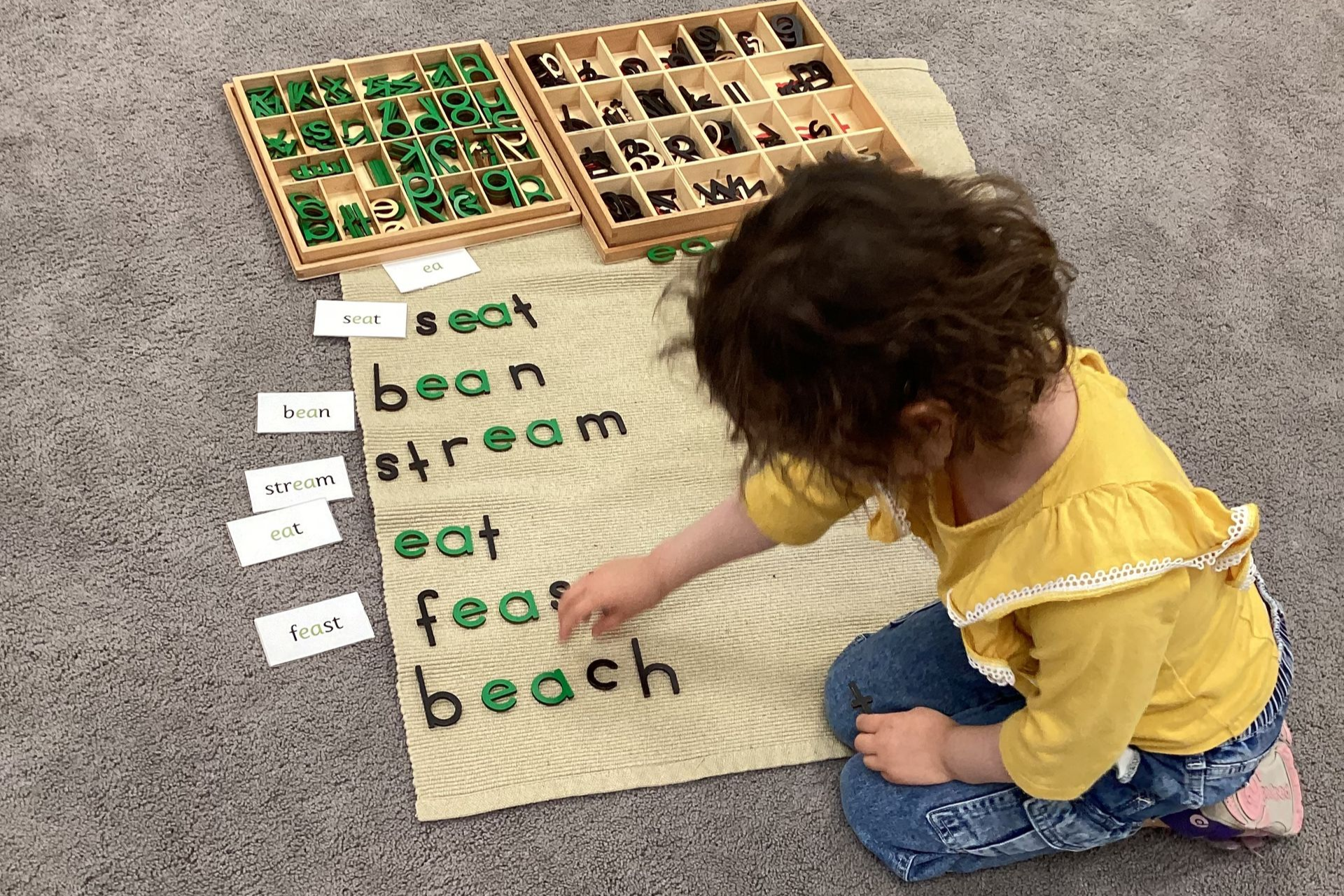 Montessori Toddler working with movable alphabet
