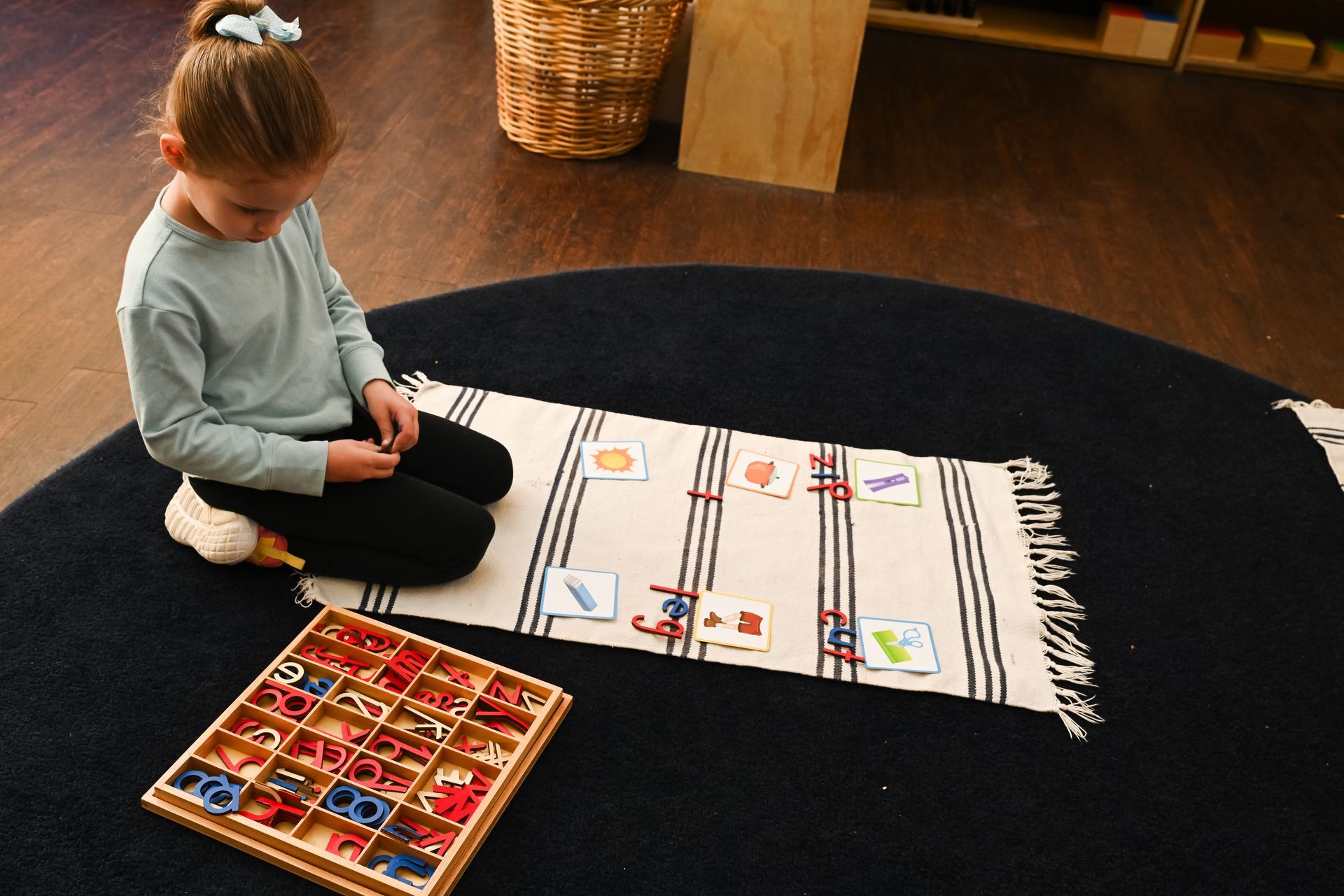 Montessori child working the movable alphabet.