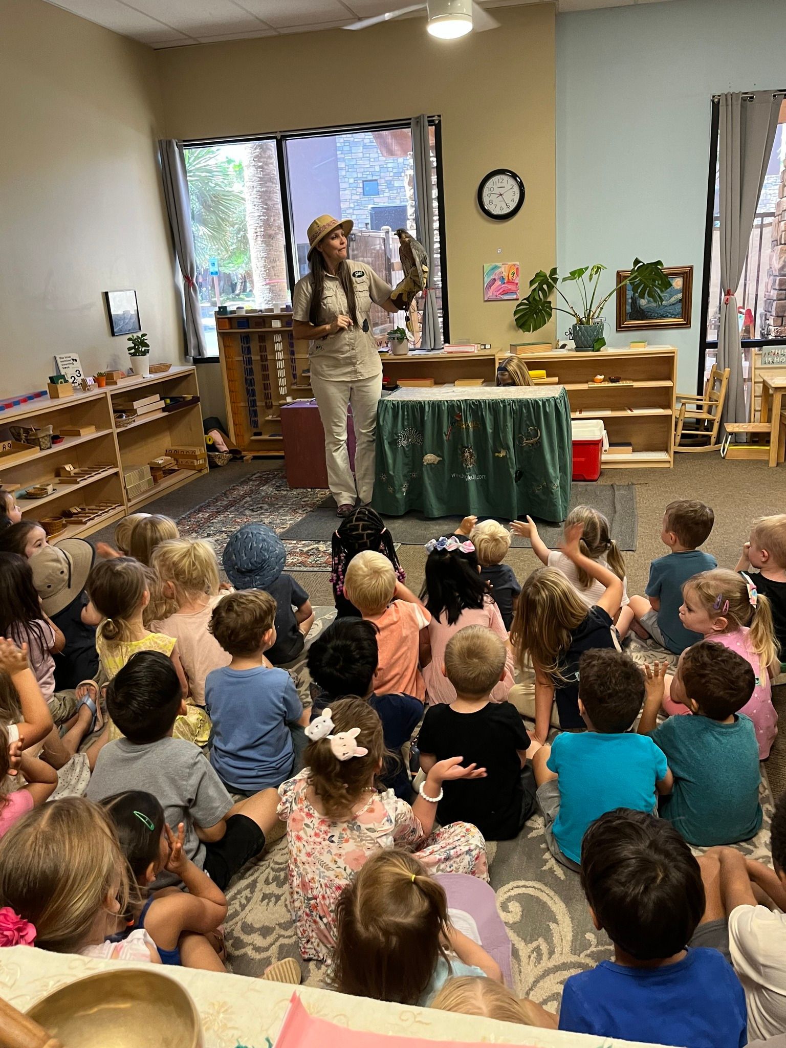 Montessori guide and childrens working in the classroom