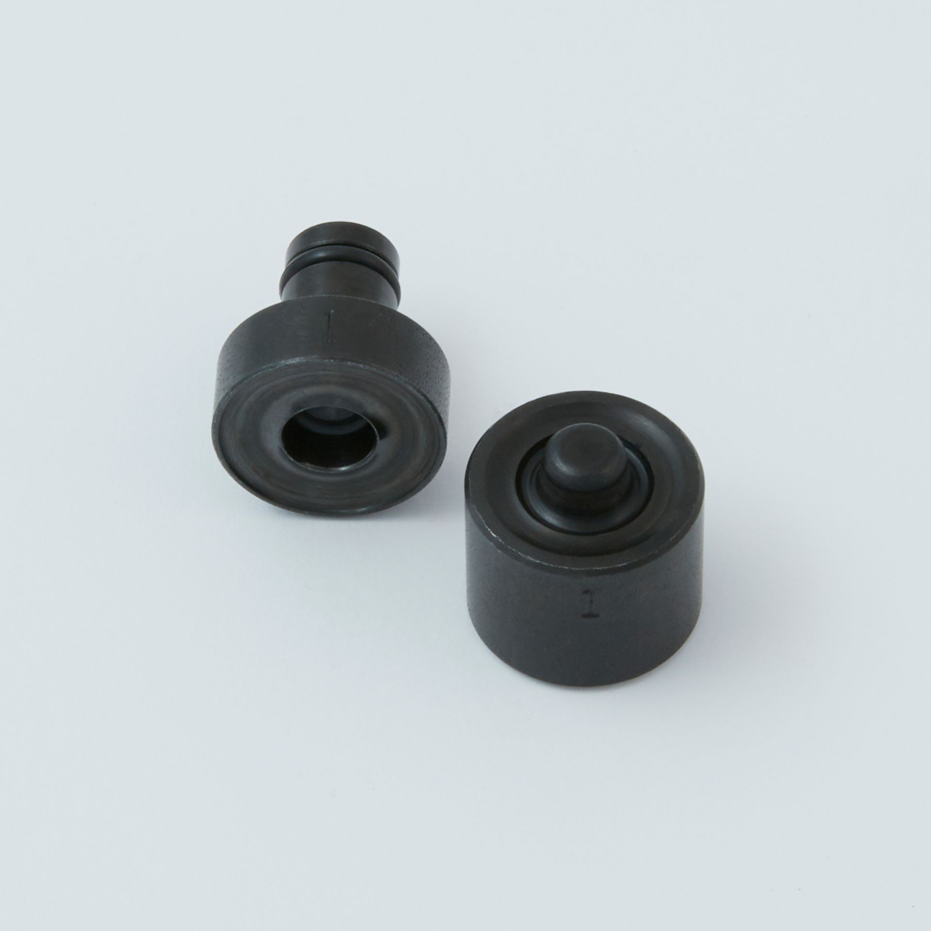 Black tool with a serrated end and a small metal clip next to it.