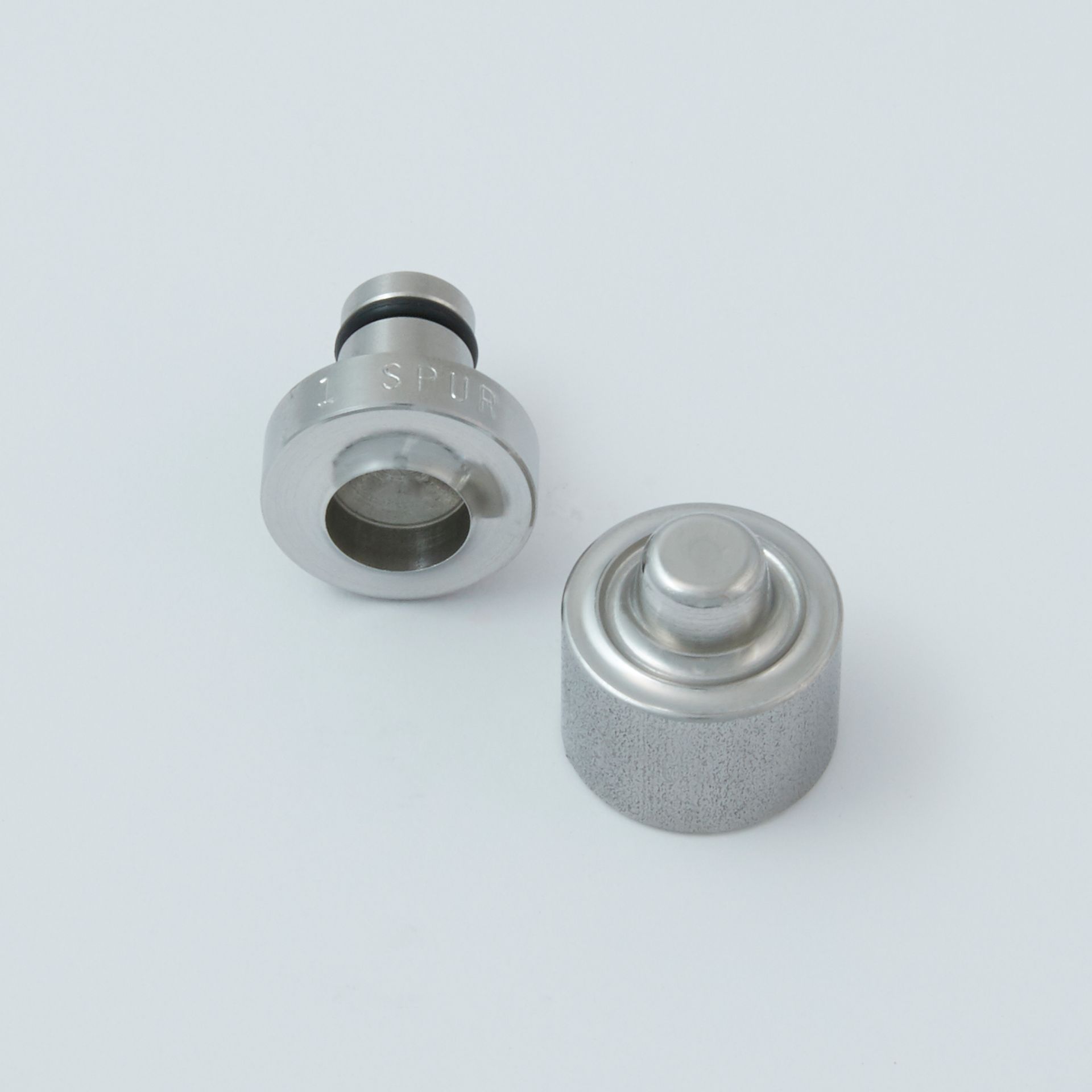 Black tool with a serrated end and a small metal clip next to it.