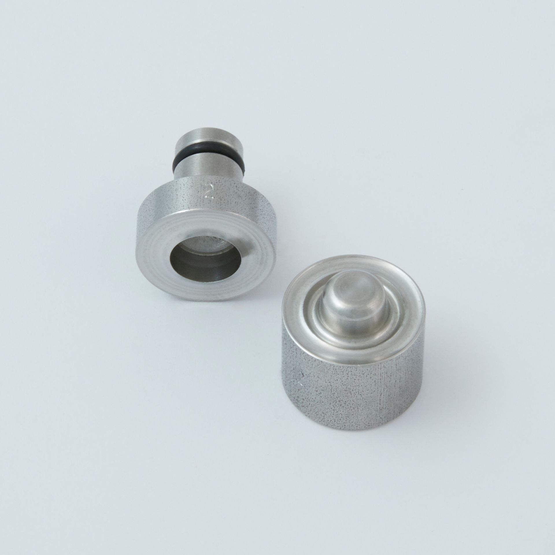 Black tool with a serrated end and a small metal clip next to it.