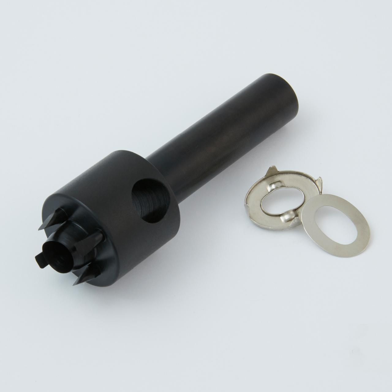 Black tool with a serrated end and a small metal clip next to it.