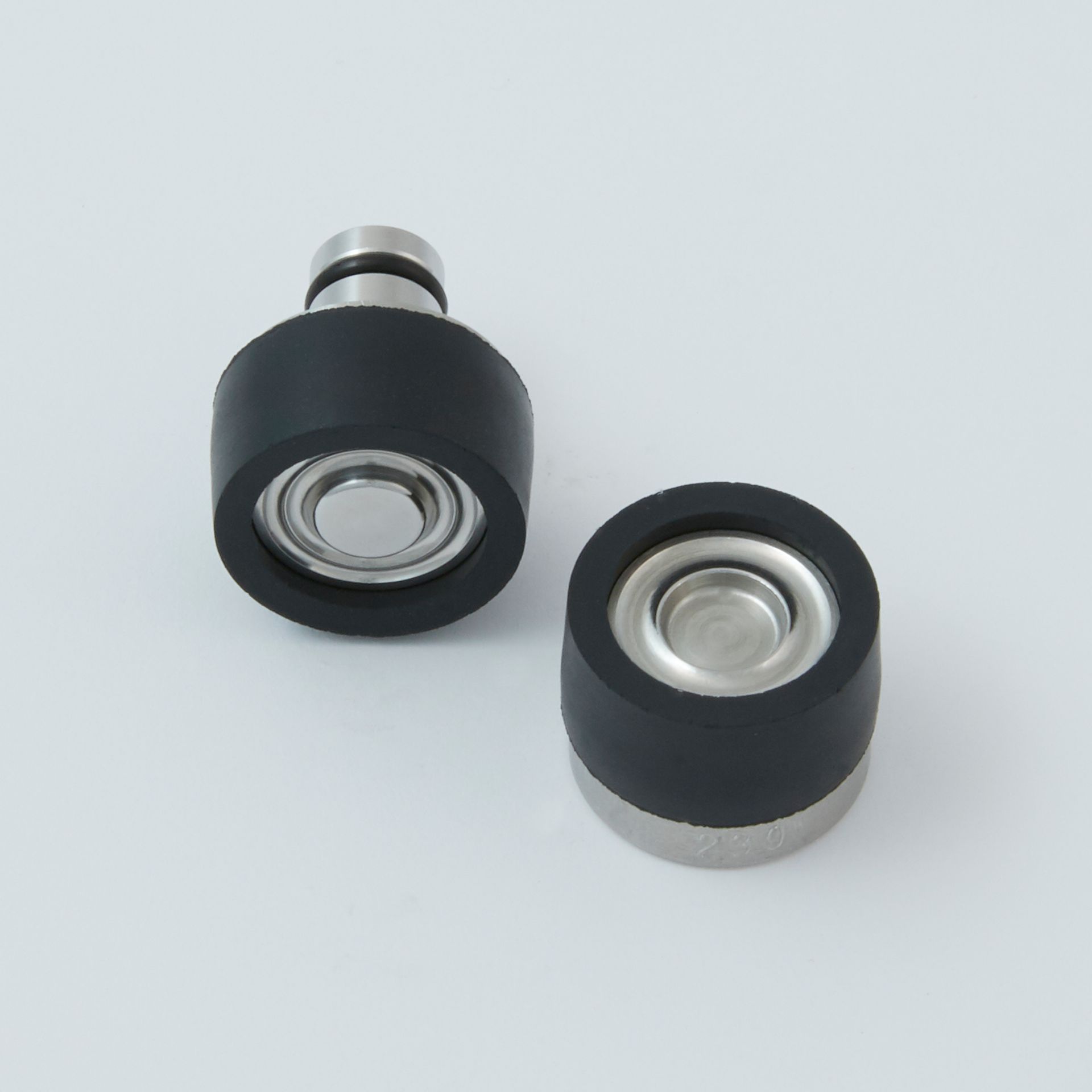 Black tool with a serrated end and a small metal clip next to it.