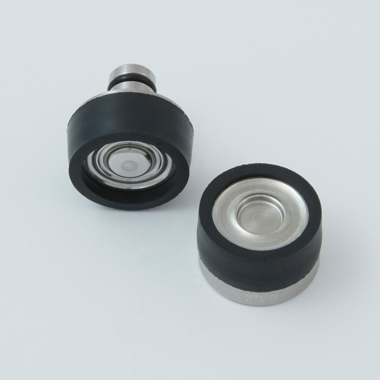 Two cylindrical metal and rubber components. One with a stem, the other without.