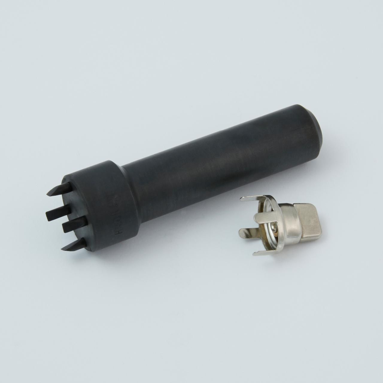 Black plastic tool with prongs next to a metal connector.