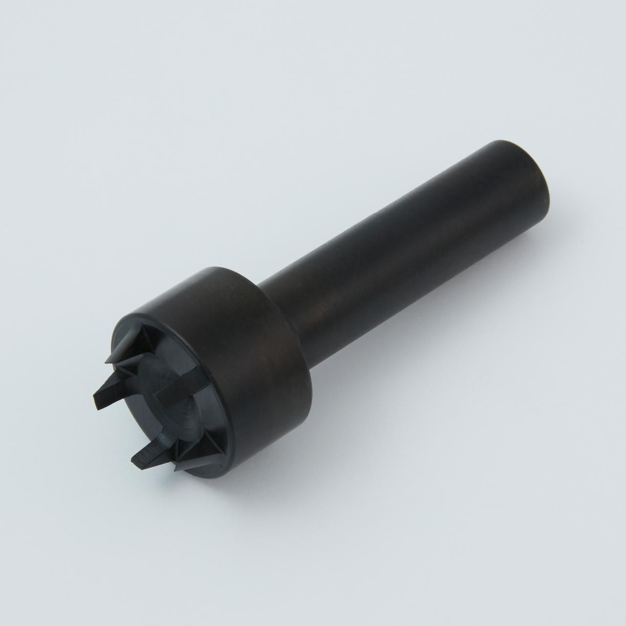 Black plastic tool with a cylindrical handle and a star-shaped head with prongs.