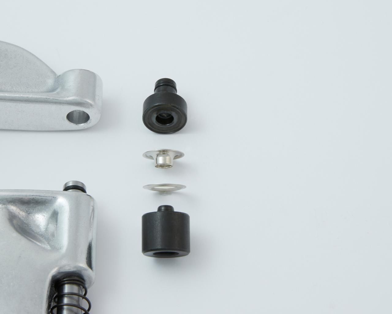 Parts of a rivet press and rivets.