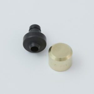 Black tool with a serrated end and a small metal clip next to it.