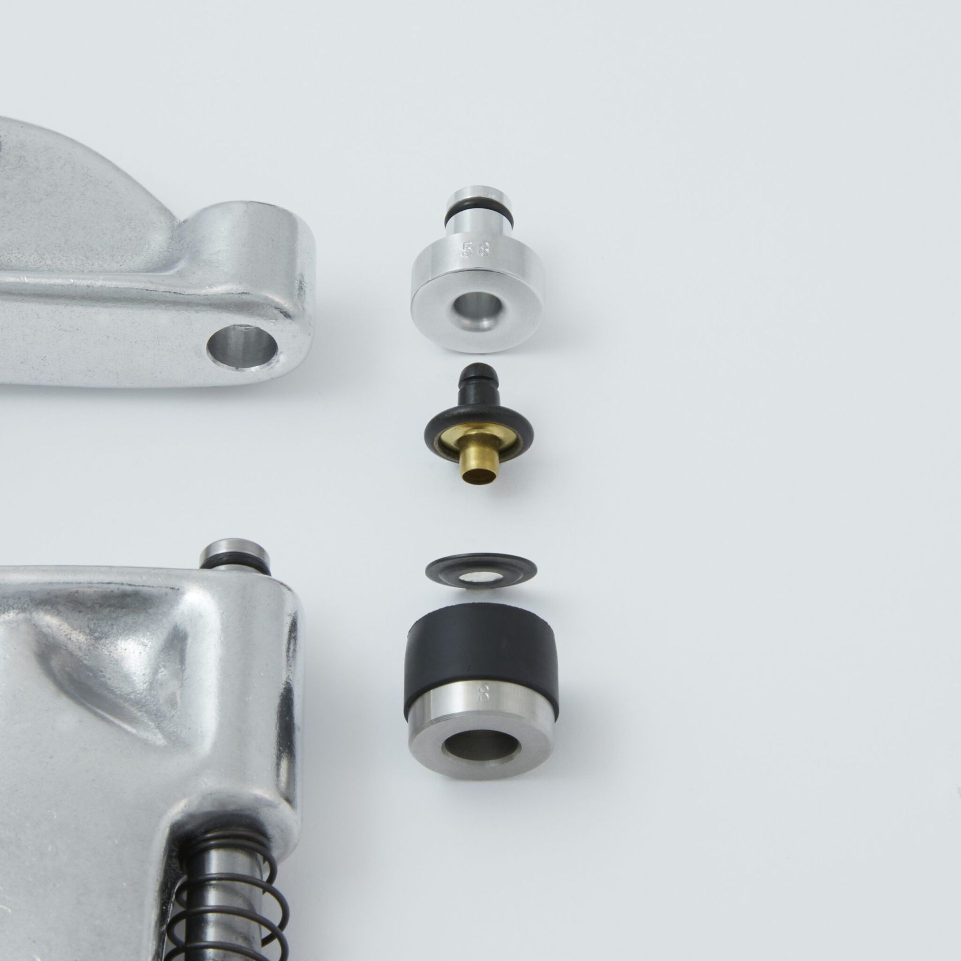 Exploded view of motorcycle brake master cylinder components, including a piston, seals, and housing.