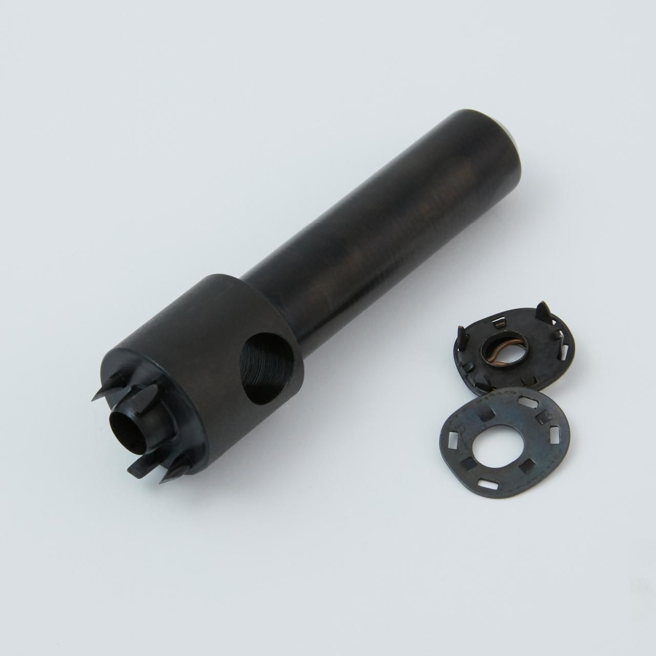 Black metal tool with two small, circular, perforated metal pieces.