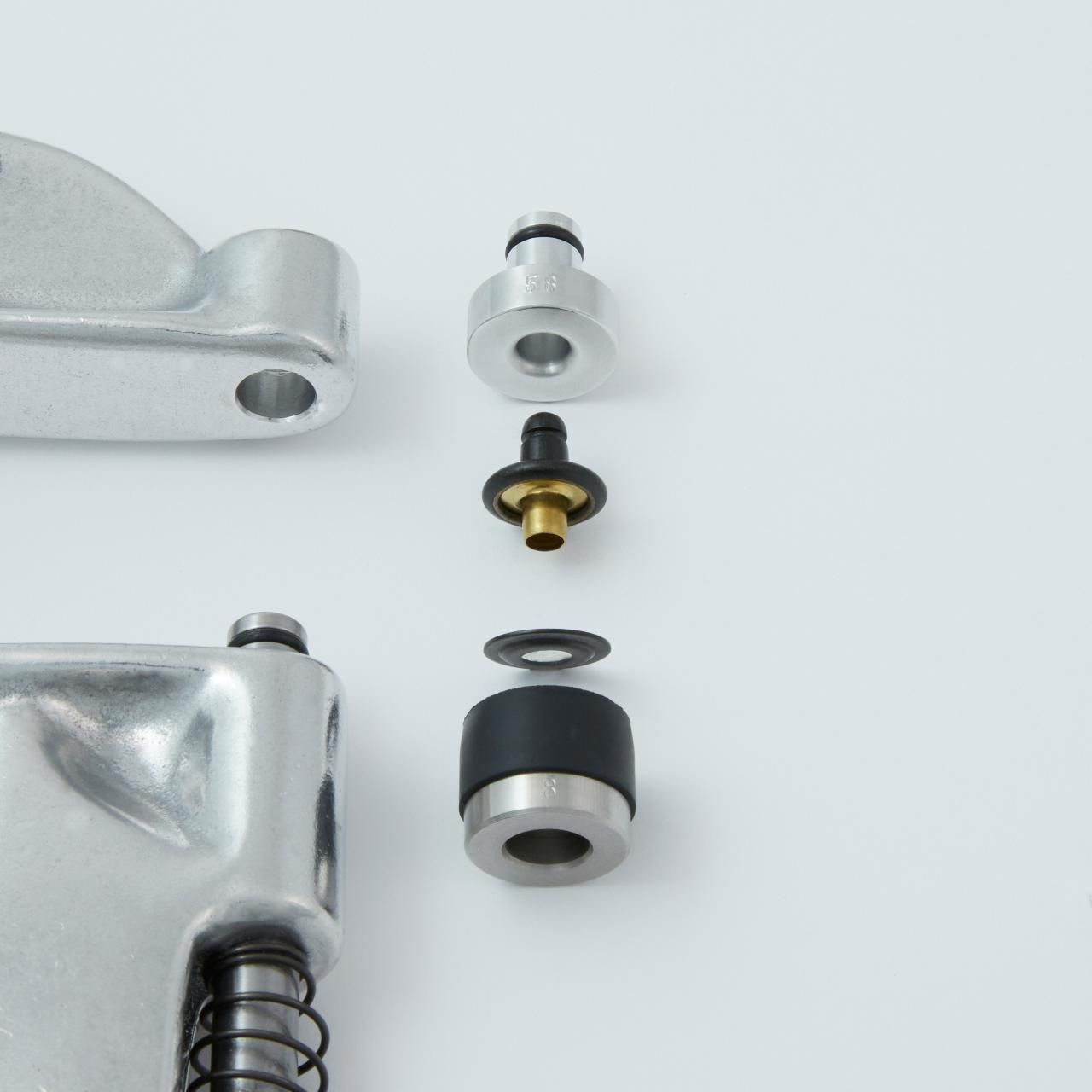 Exploded view of a mechanical component with metal and rubber parts.