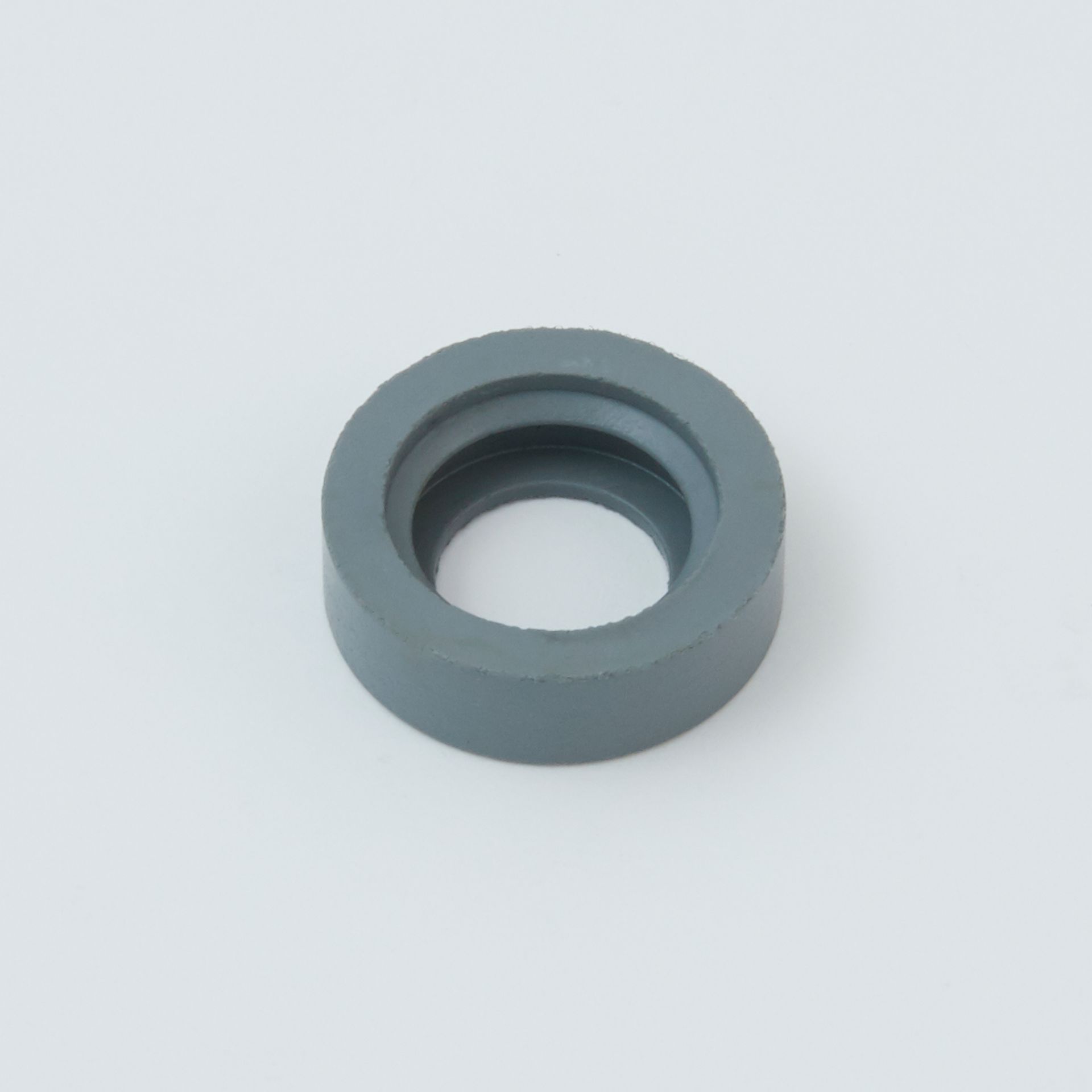 Black tool with a serrated end and a small metal clip next to it.