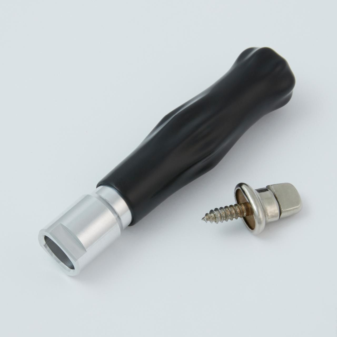 Black-handled tool and screw. Tool has a silver head. Screw has a screw, metal head and a washer.