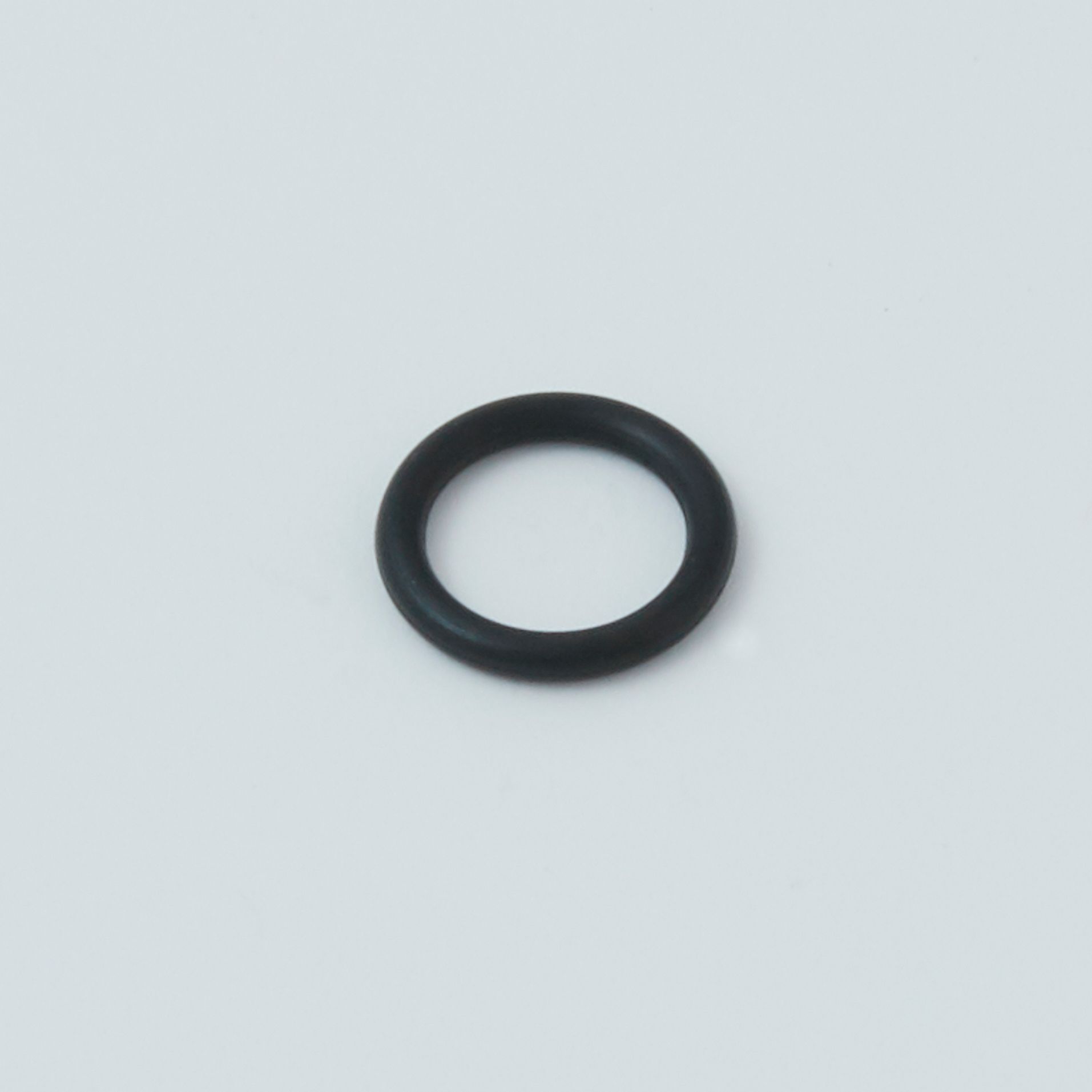 Black tool with a serrated end and a small metal clip next to it.