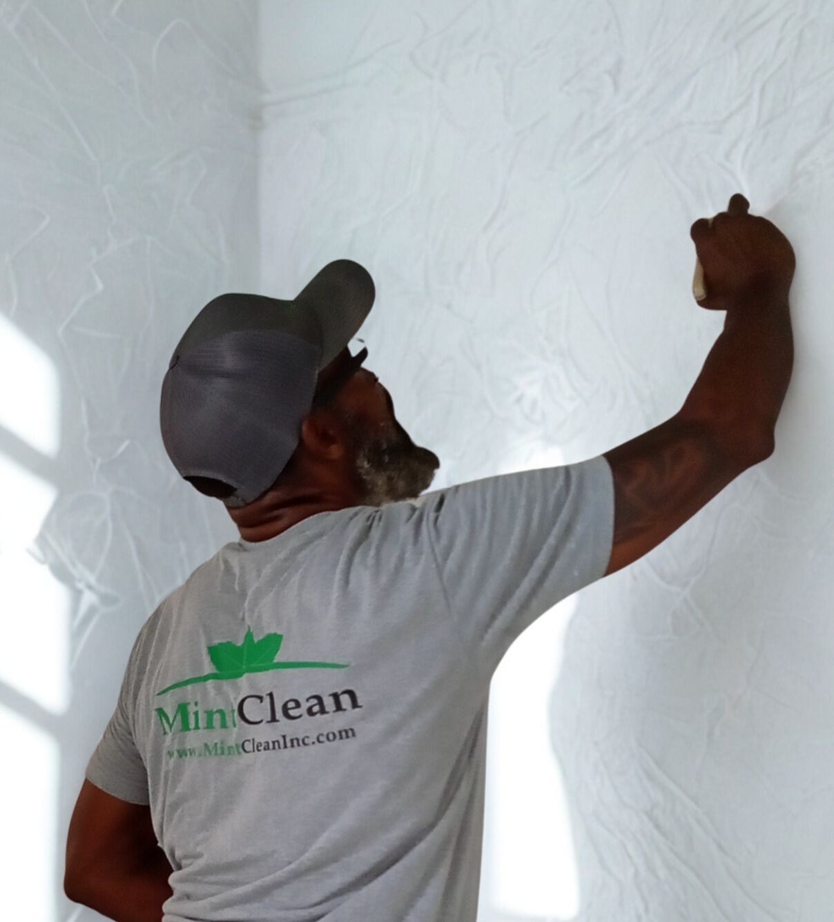 A plumber is laying on the floor fixing a sink.