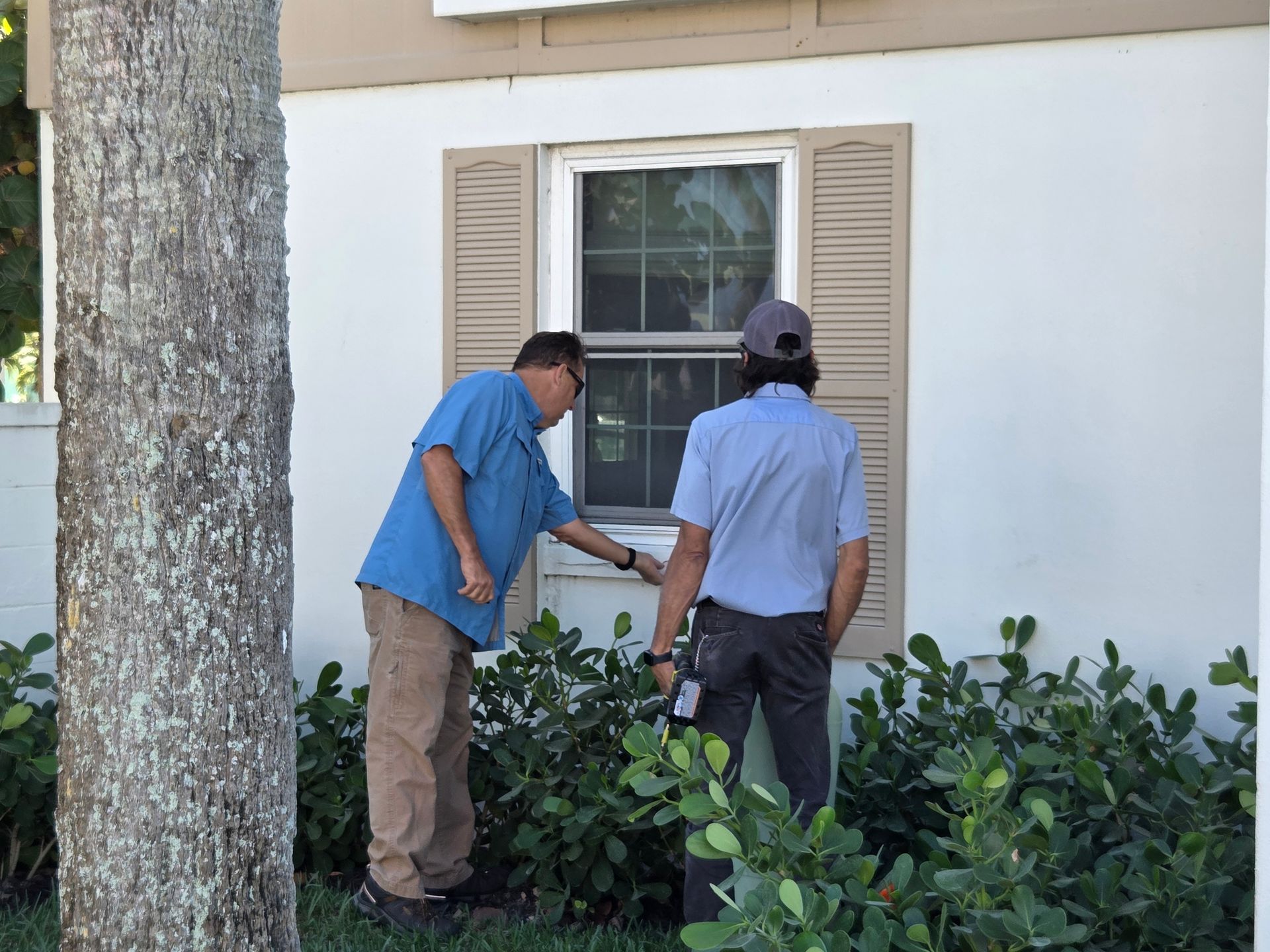 A plumber is fixing a sink with a wrench.