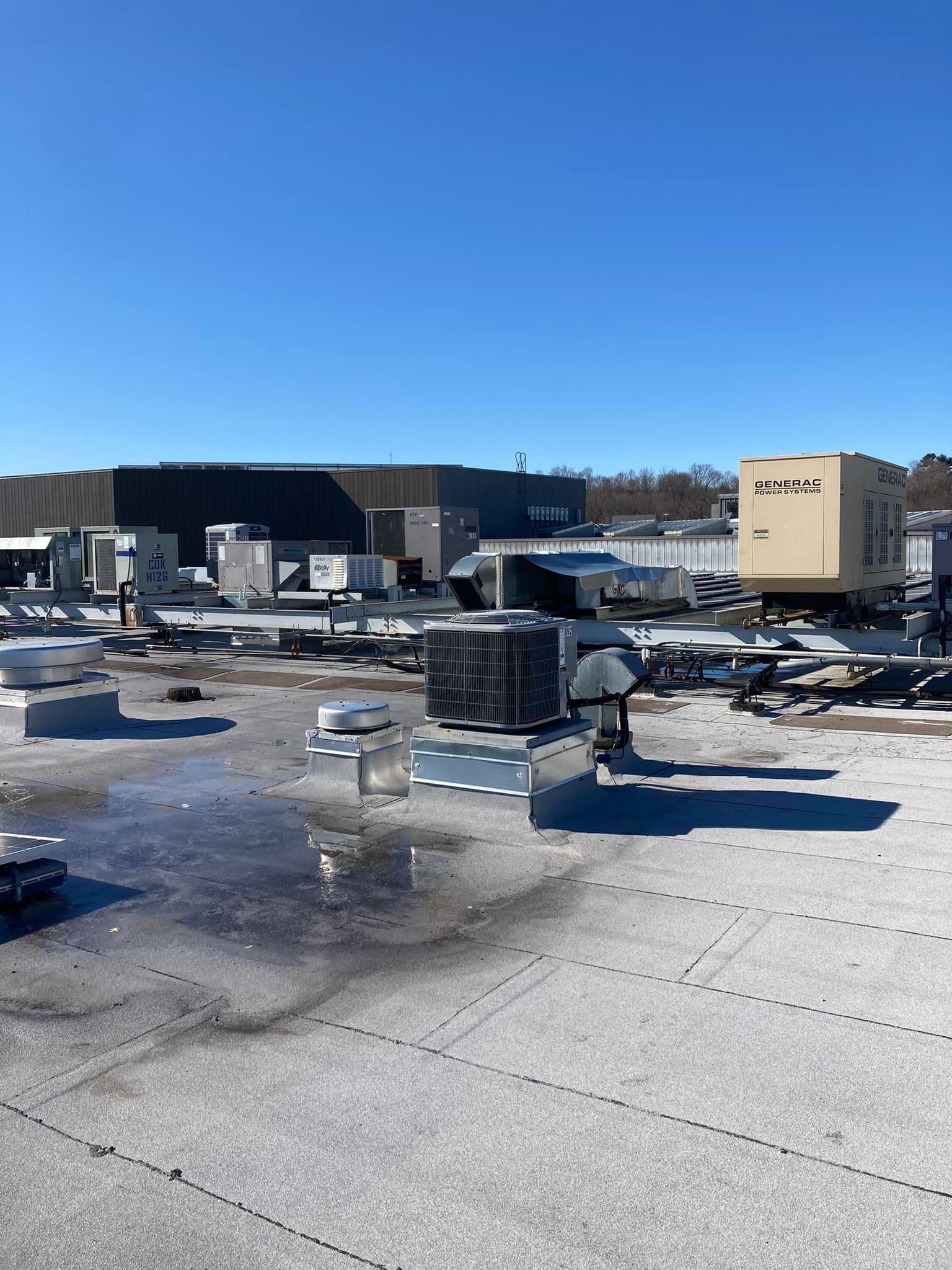 The roof of a building with a lot of air conditioners on it.