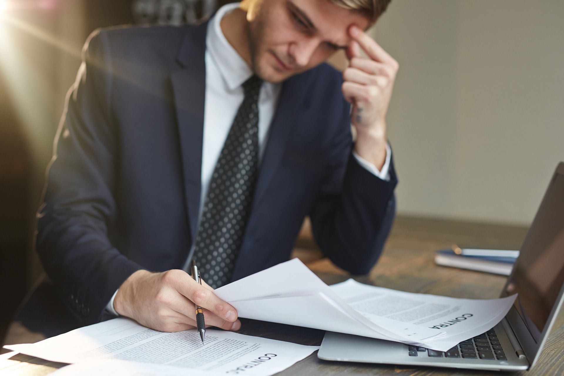 A business owner is reviewing contracts and checklists for legal compliance.